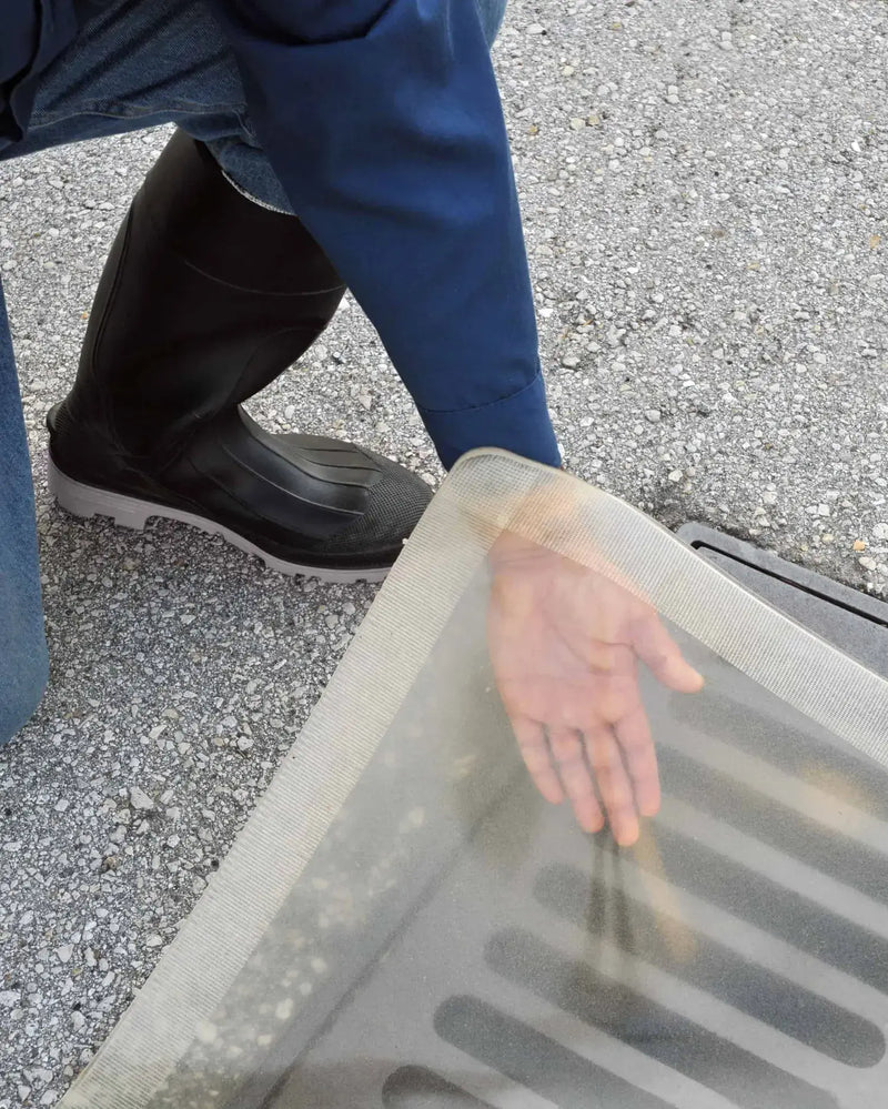 Ultra Drain Seal Clear Model closeup of hand under liner