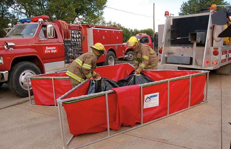 Husky Portable Steel Collapsible Folding Frame Water Tank being folded